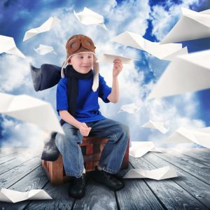 Boy Pilot with Paper Airplanes Flying in Sky