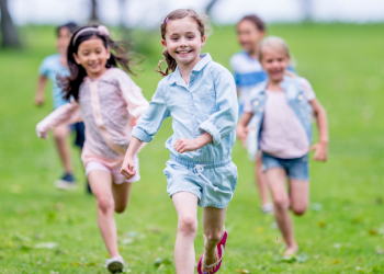 The 5 Best Gifts for Children-Dr. Arielle Schwartz 3 5 children running on green grass, 3 in main frame and 2 out of focus.
